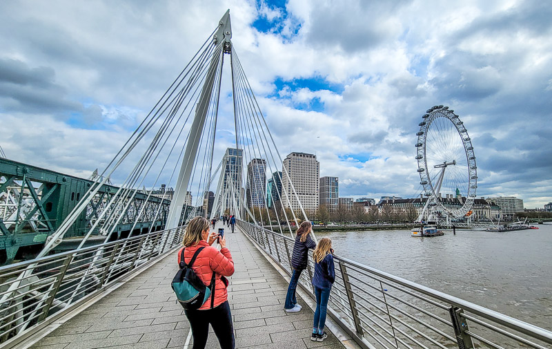 people walking across a bridge