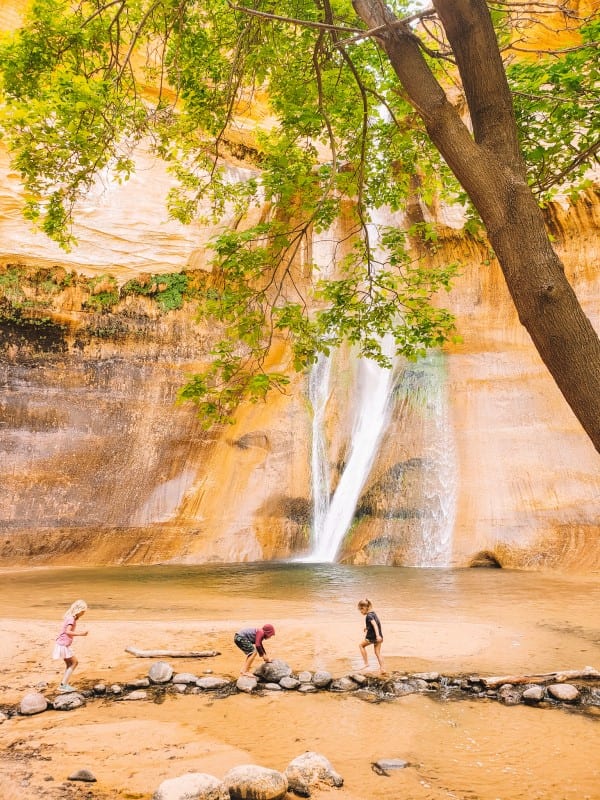 kids playing at the base of lower calf creek falls grand staircase escalante national monument utah (1)