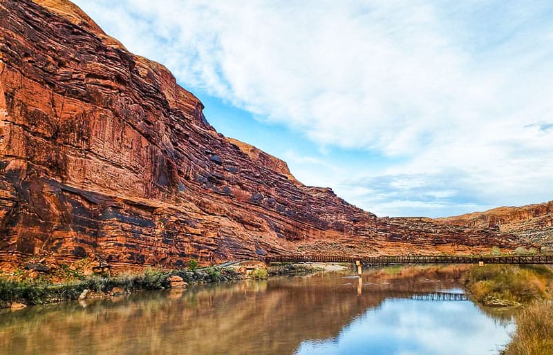 colorado river next to red cliffs in moab