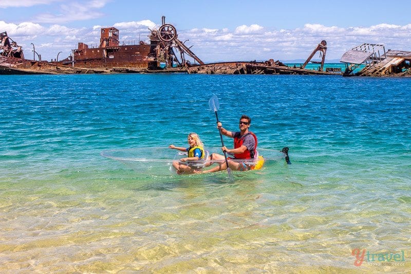 man and child in glass bottom kayak near shipwreck on morton island