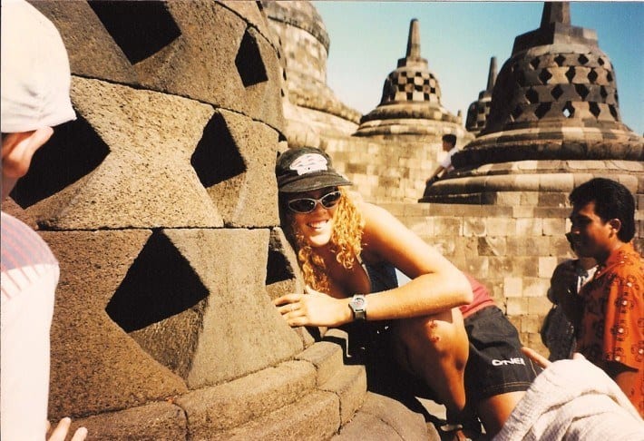 woman reaching in to Borobudur temples Java