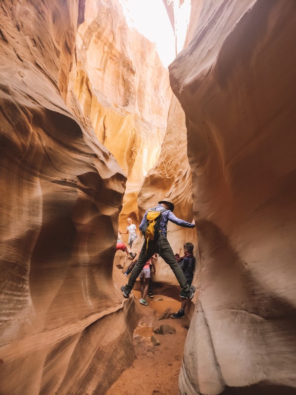 man spider walking through slot canyon grand staircase