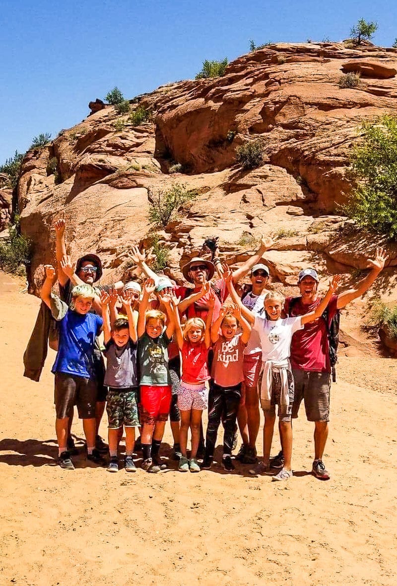 group of people with hands in air posing in celebration