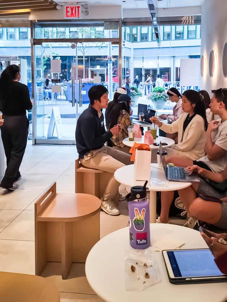 people sitting at tables at ten thousand coffee