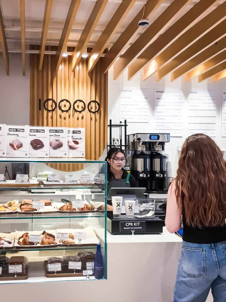 girl ordering at ten thousand coffee counter