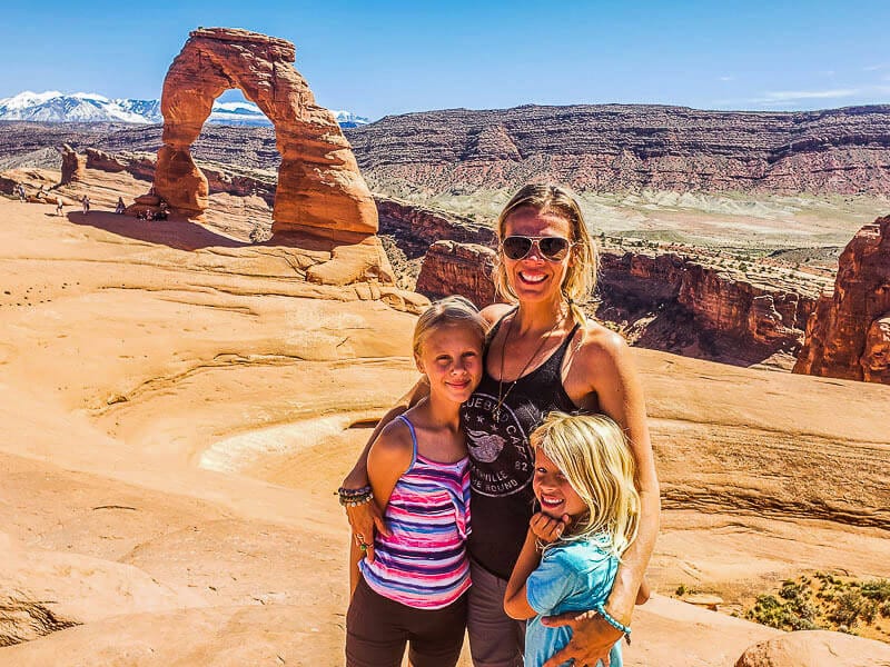 people standing in front of delicate arch