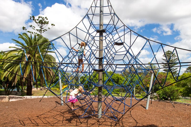 girls climbing spider web at Queens Park Playground 