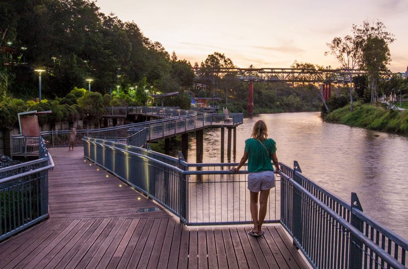 woman on Bremer River boradwalk looking at bridge