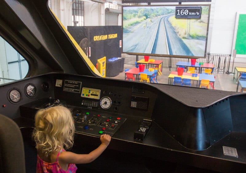 girl pretending to drive a train at Ipswich Railway Museum