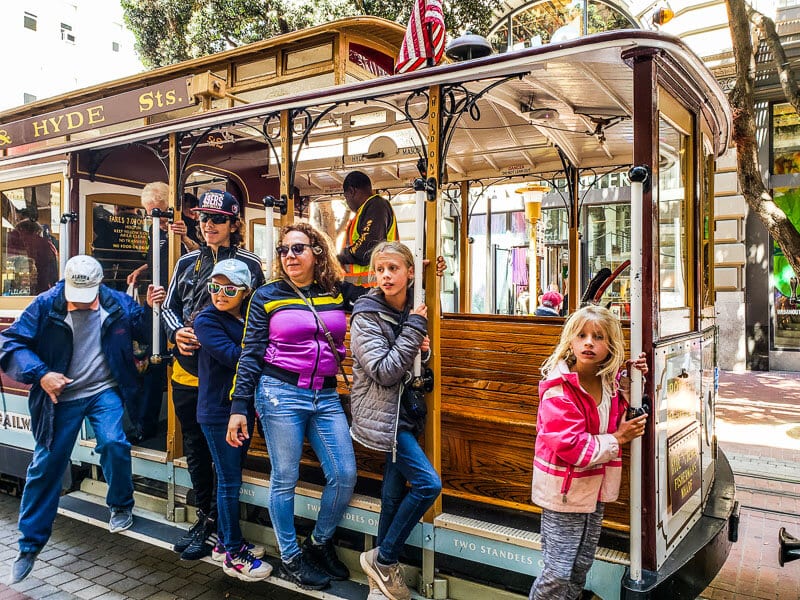 people standing on a cable car