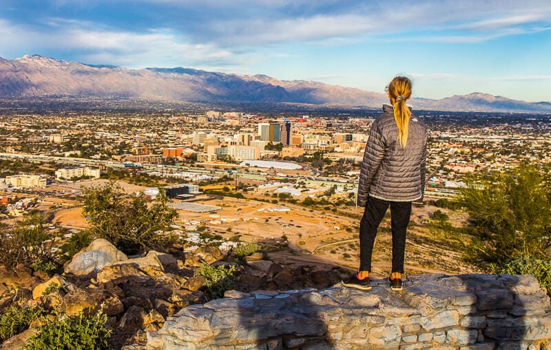 girl looking at the view of Tucson from A moutnain