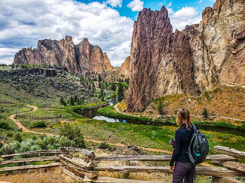 woman on trail looking at jagged rock peaks on the Misery Ridge Trail, Smith Rock State Park