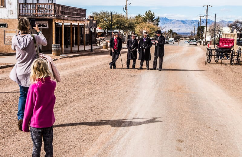 men standing in a line on a dirt road