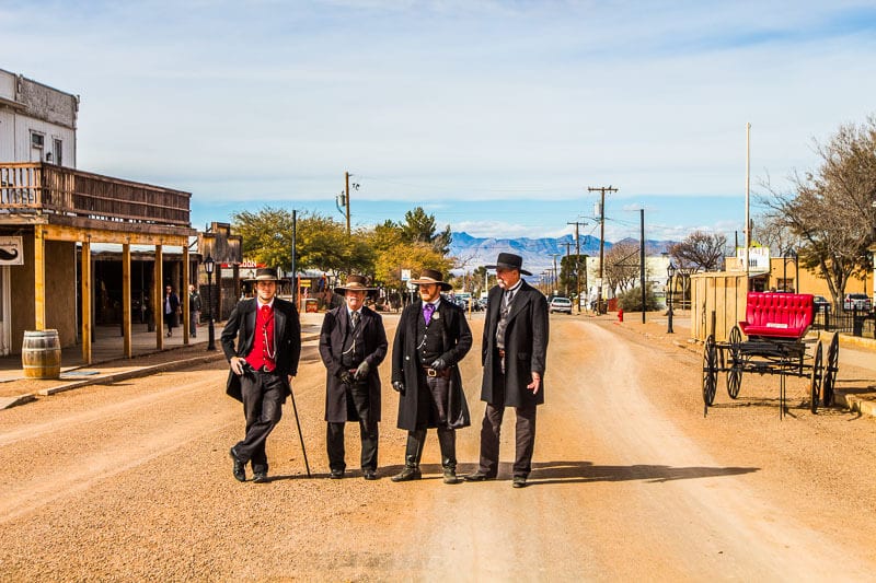 men standing on a dirt road