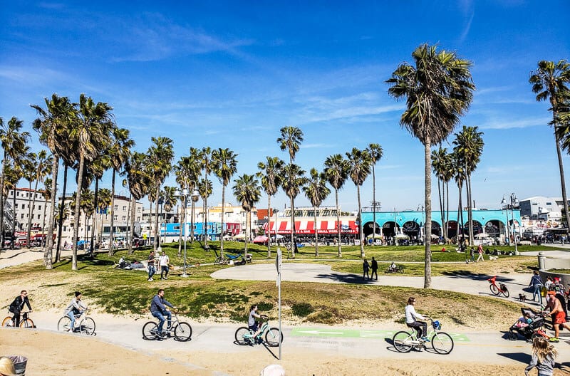 people riding bikes along venice beach