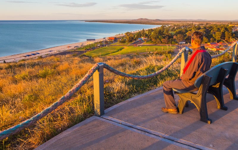 man on bench looking at view of beach at Whyalla 