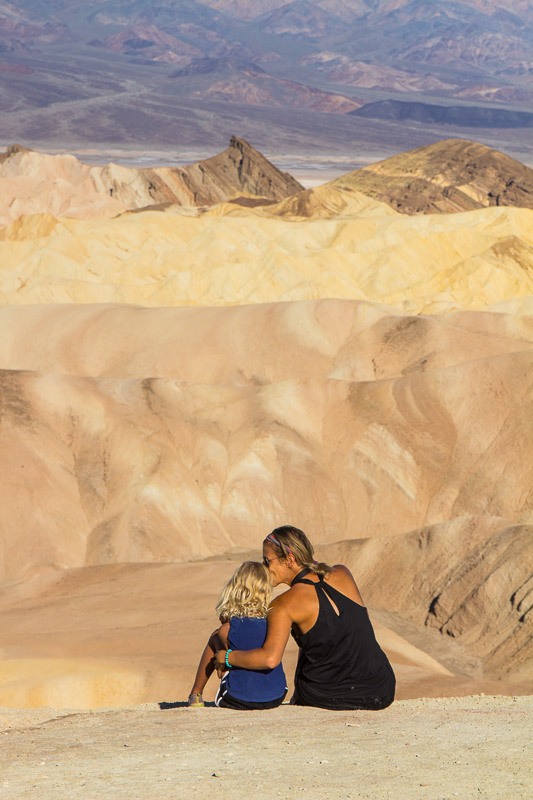 mother kissing girl on head at zabriskie point death valley np california