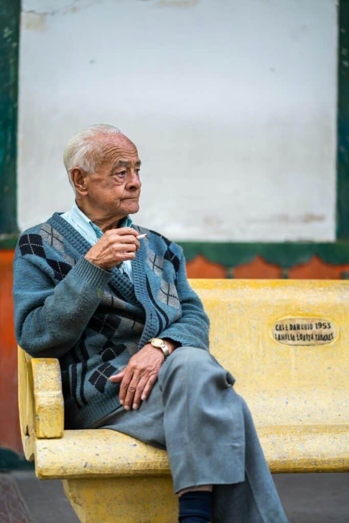 man sitting on chair smoking