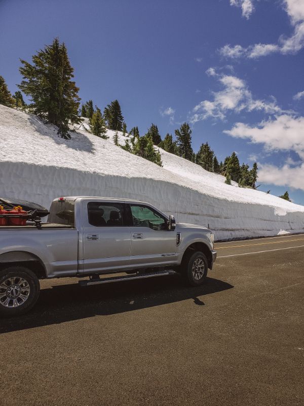 f250 near pile of snow on road