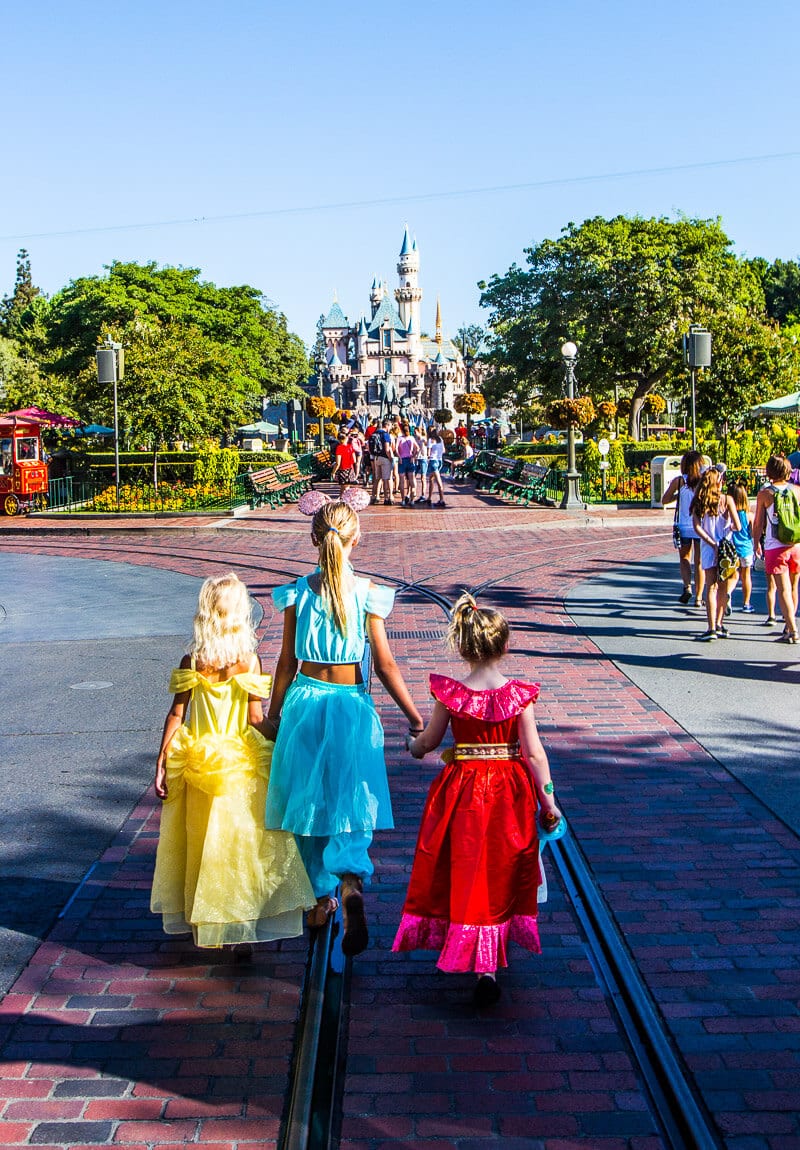 girls walking towards disneyland castle