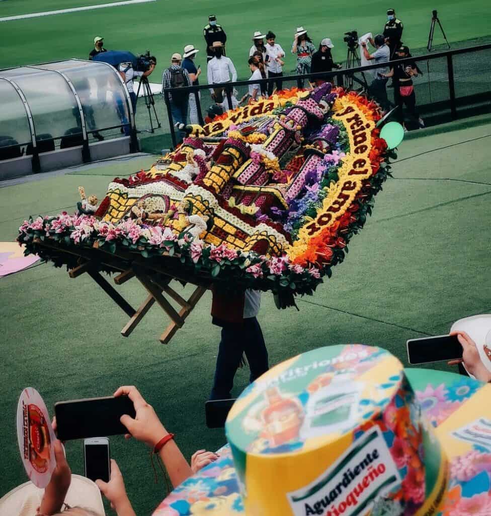 man carrying flower display