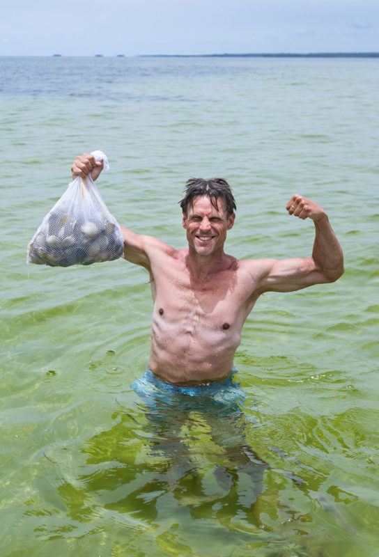 man holding bag of scallops