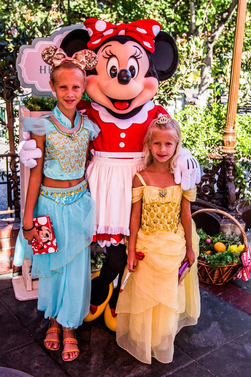 two girls posing with minnie mouse Disneyland Anaheim