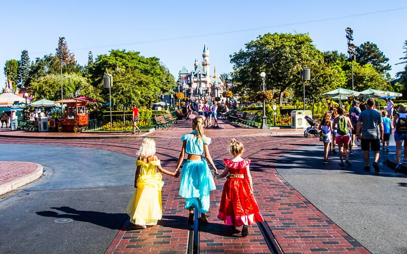 kids holding hands Walking along Main Street U.S.A. in Disneyland