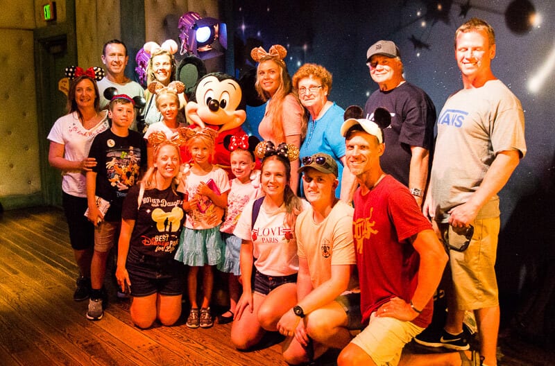 large family posing at disneyland