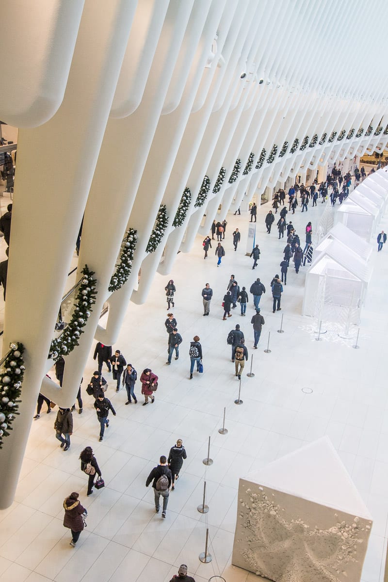 people walking Inside the Oculus at One World Trade Center in NYC. 