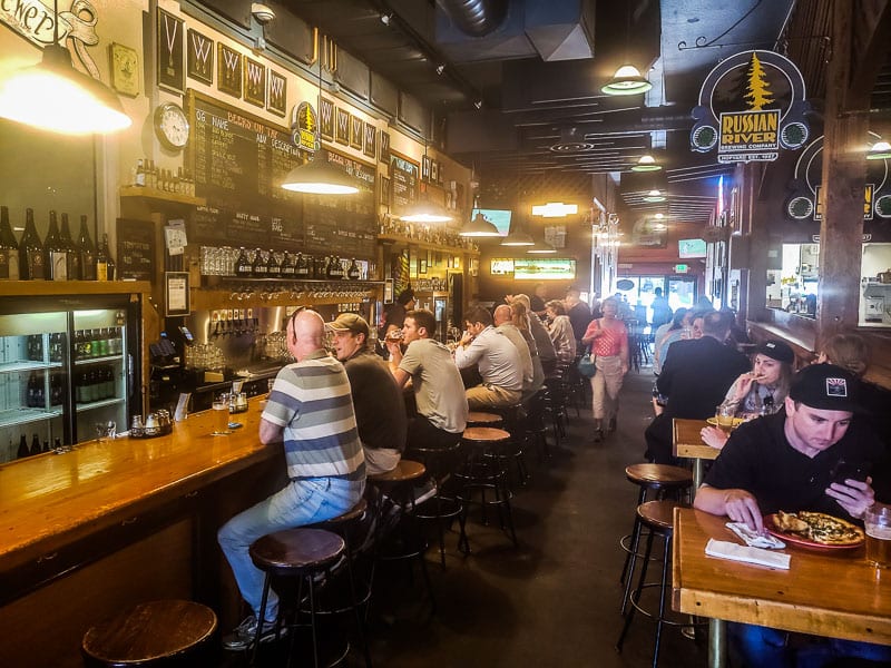 people sitting at bar in Russian River Brewing Company