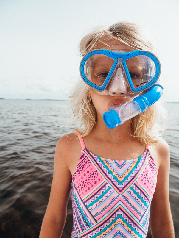 young girl wearing snorkel