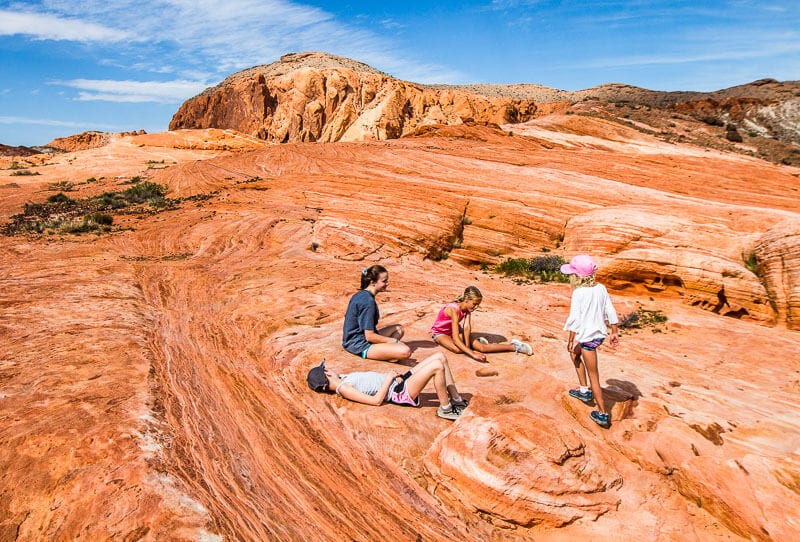 people sitting on orange and pink rocks