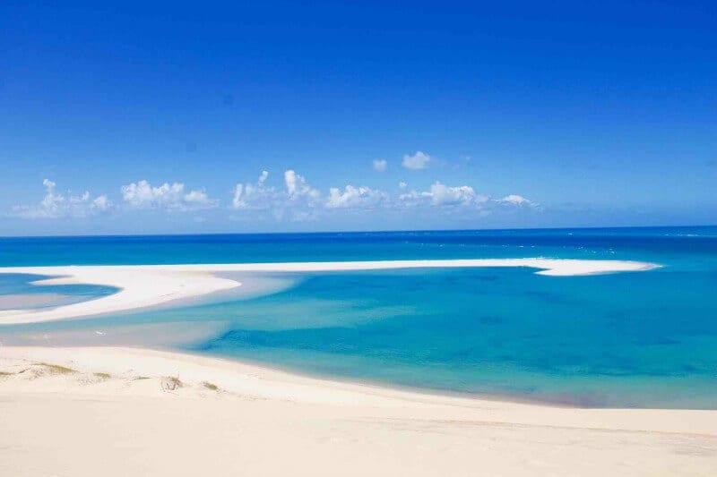 white sand swirling through turquoise water of Mozambique beach