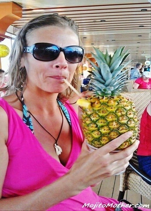 a woman drinking out of a pineapple