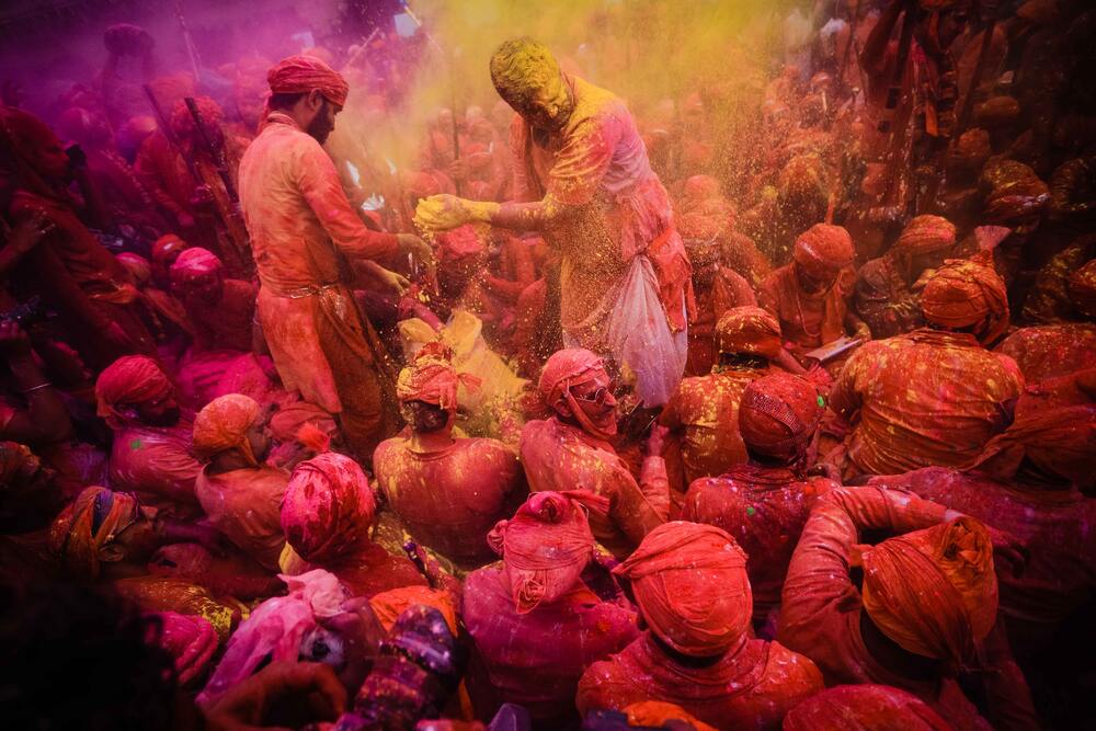 crowds covered in paint at Holi, India