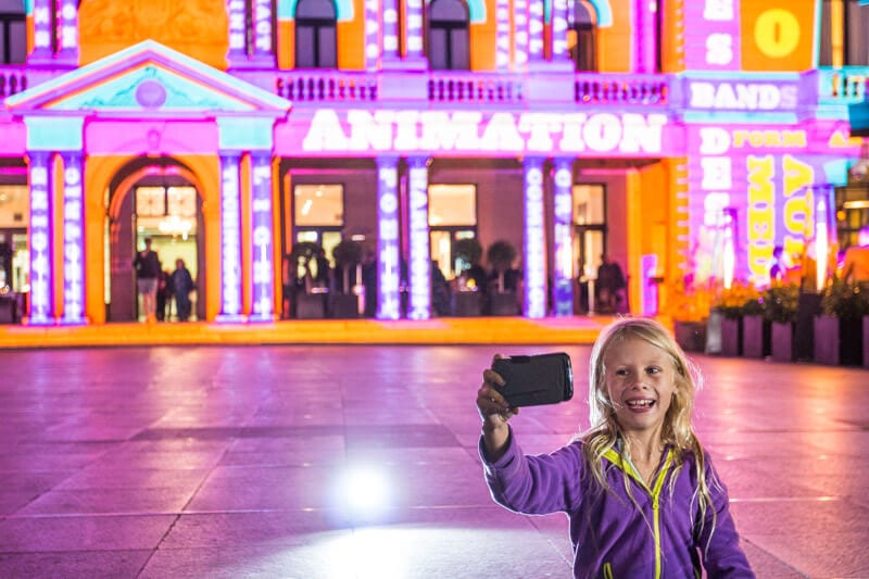 girl taking selfie at Customs House during Vivid Sydney