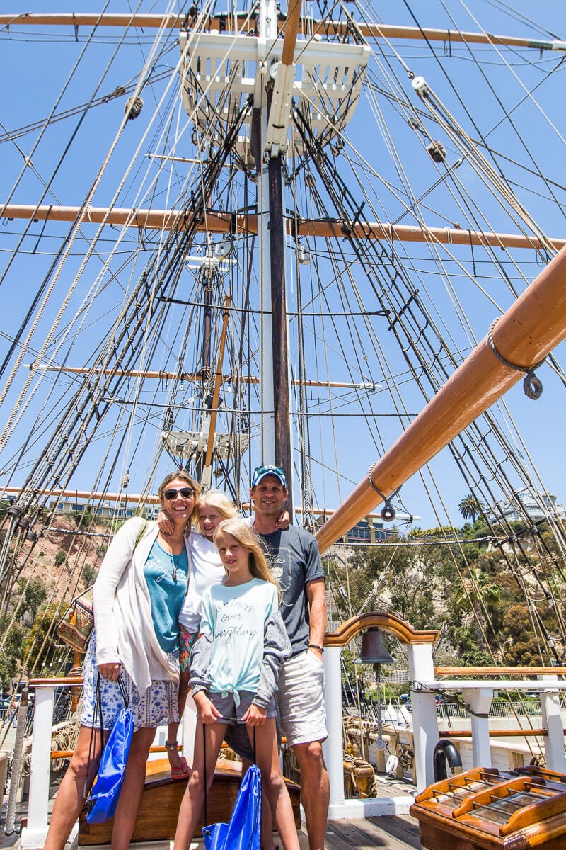 family posin gon deck of Pilgrim tall ship at Ocean Institute Dana Point