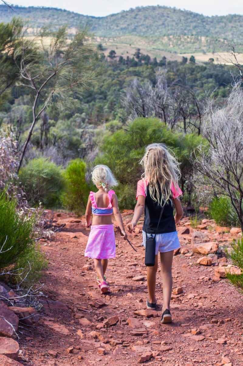 girls walking on a dirt road