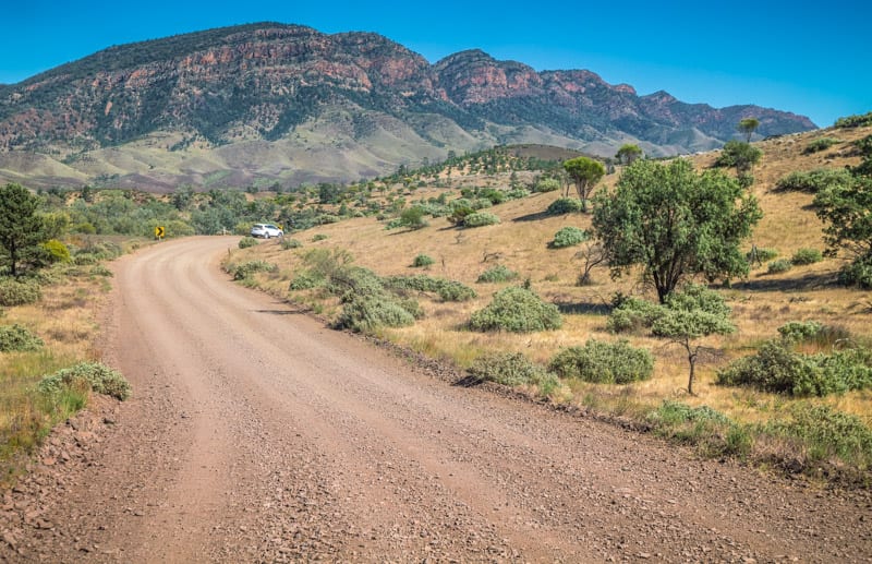 mountains next to a dirt road