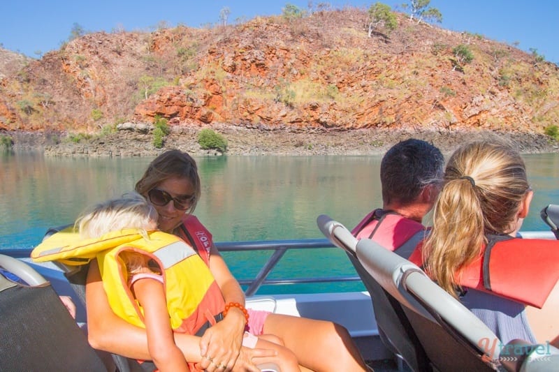 woman and child sitting on jet boat