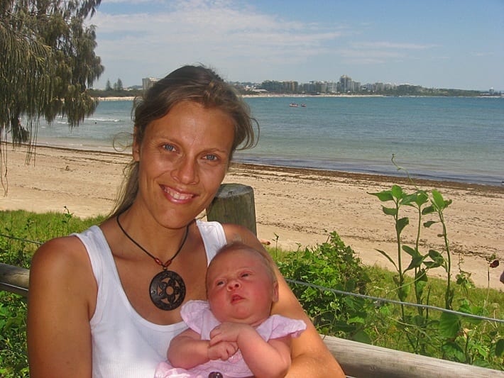 woman holding a baby and smiling