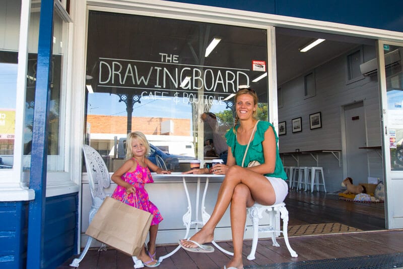 mother and child sitting outside cafe