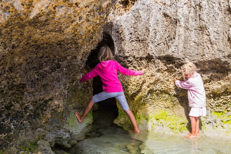 girls playing on rocks Stokes Bay