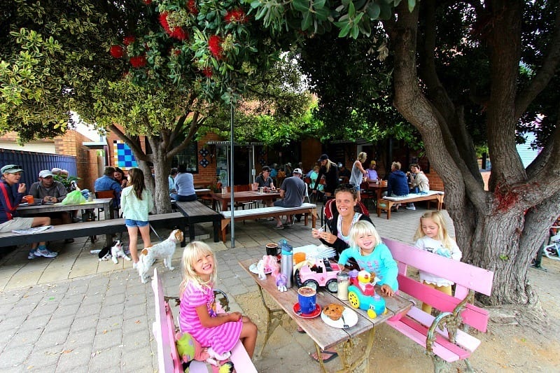 family enjoying brunch under a tree