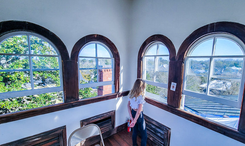 girl looking out window of Bellamy House, Wilmington