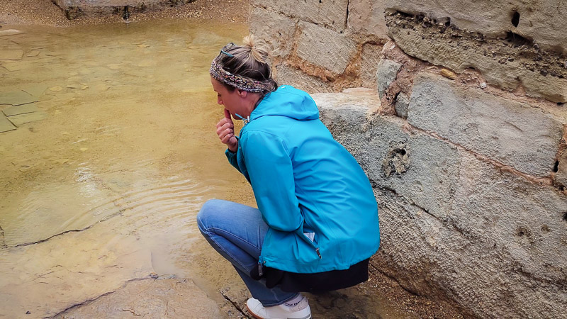 woman blessing herself with water Where Jesus was baptized Jordan