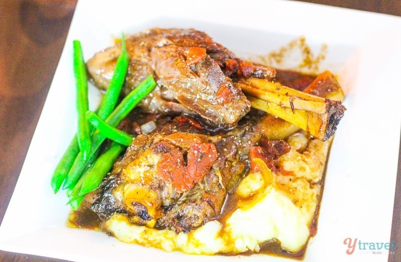 plate of lam shanks with mash gravy and green beans