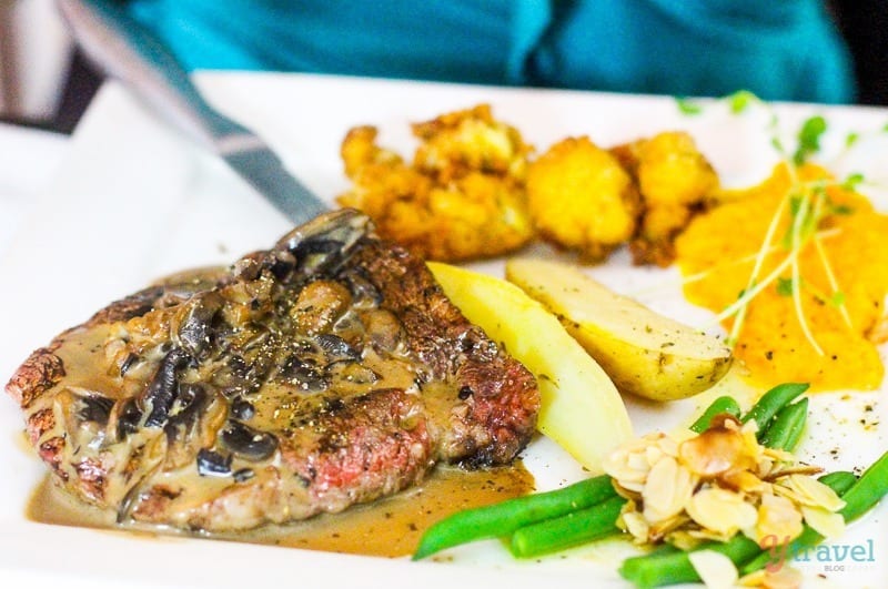 steak with mushroom sauce and vegetables