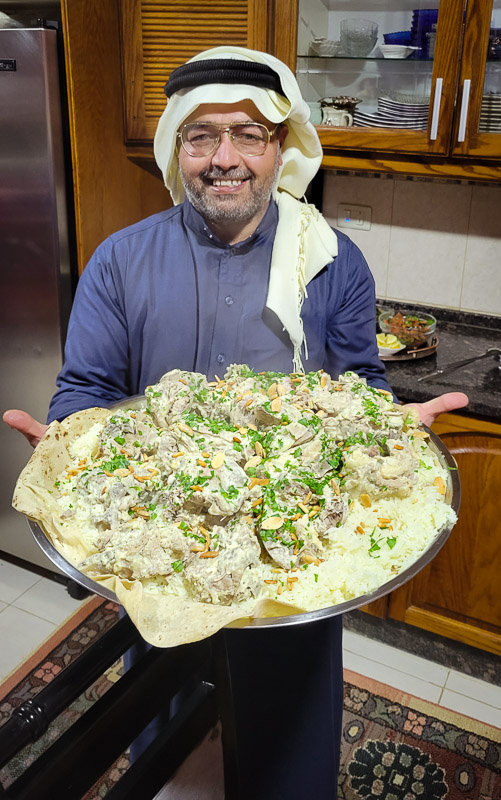 man holding a tray of nachos